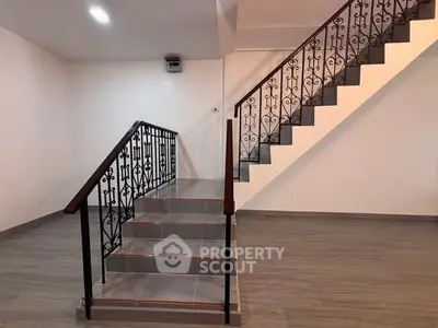 Elegant staircase with ornate railing in modern interior space