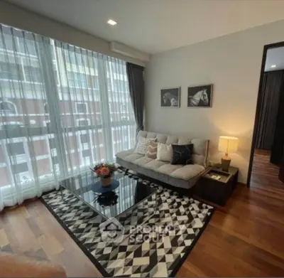 Modern living room with stylish decor and large windows in a contemporary apartment.