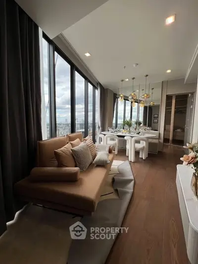Luxurious high-rise living room with panoramic city views and elegant dining area.