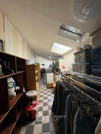 Spacious storage room with organized shelves and natural light from skylights.