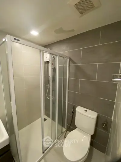 Modern bathroom with sleek shower enclosure and contemporary tile design.