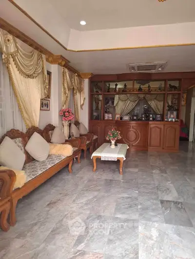 Elegant living room with classic wooden furniture and marble flooring