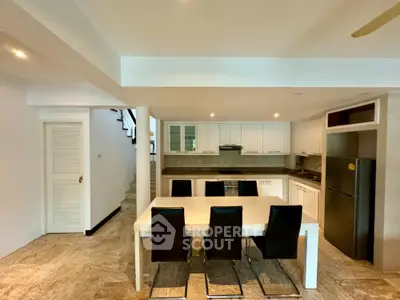 Spacious modern kitchen with sleek design and dining area
