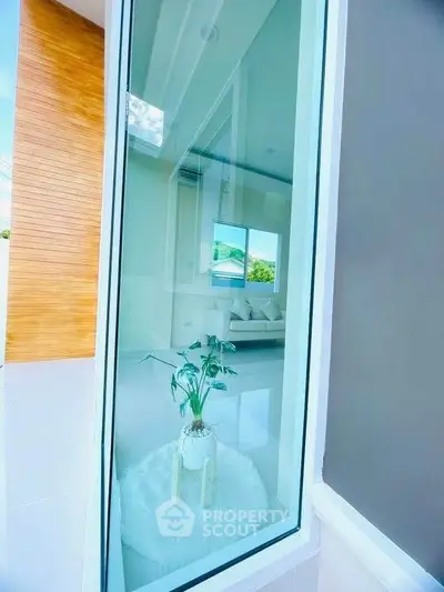 Modern home with large window showcasing bright interior and stylish decor