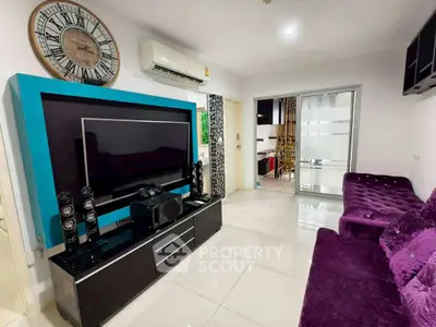 Modern living room with sleek entertainment center and plush purple sofa