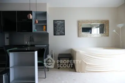 Modern studio apartment with sleek kitchen and cozy living area