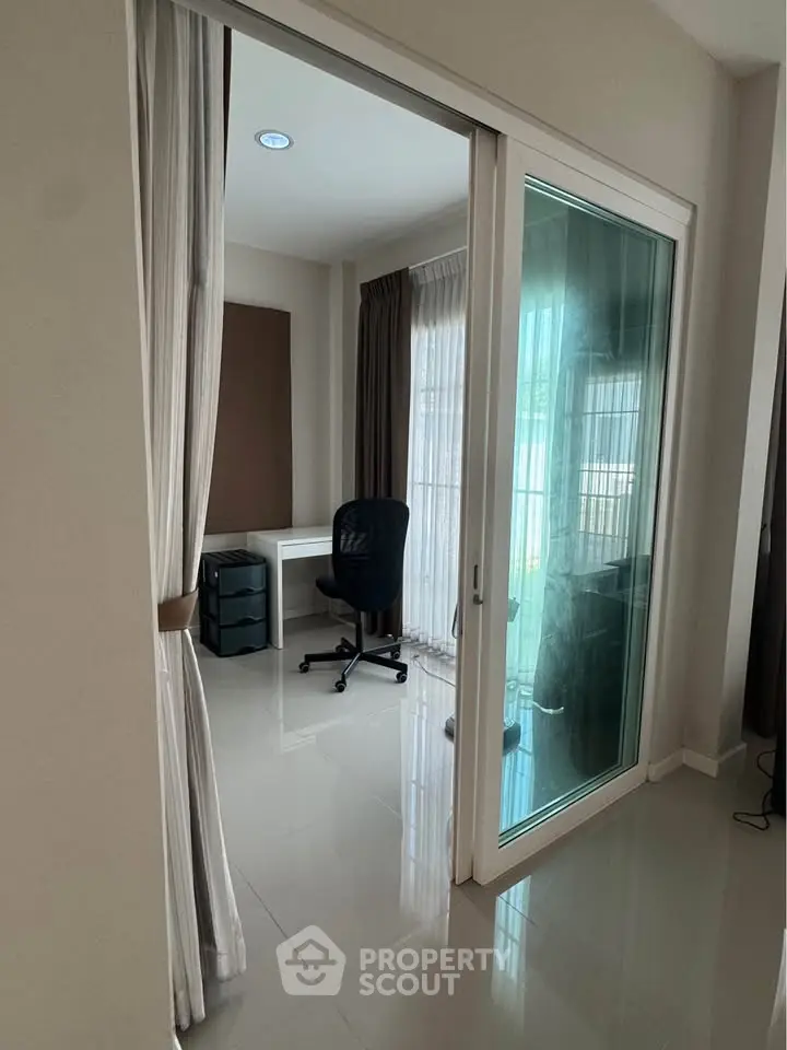 Modern study room with glass sliding door and sleek furniture