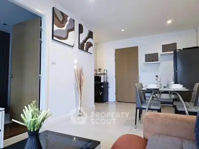 Modern living room with dining area and stylish decor in a contemporary apartment.