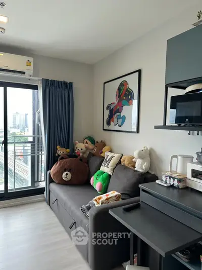 Cozy living room with plush toys, modern decor, and city view balcony.