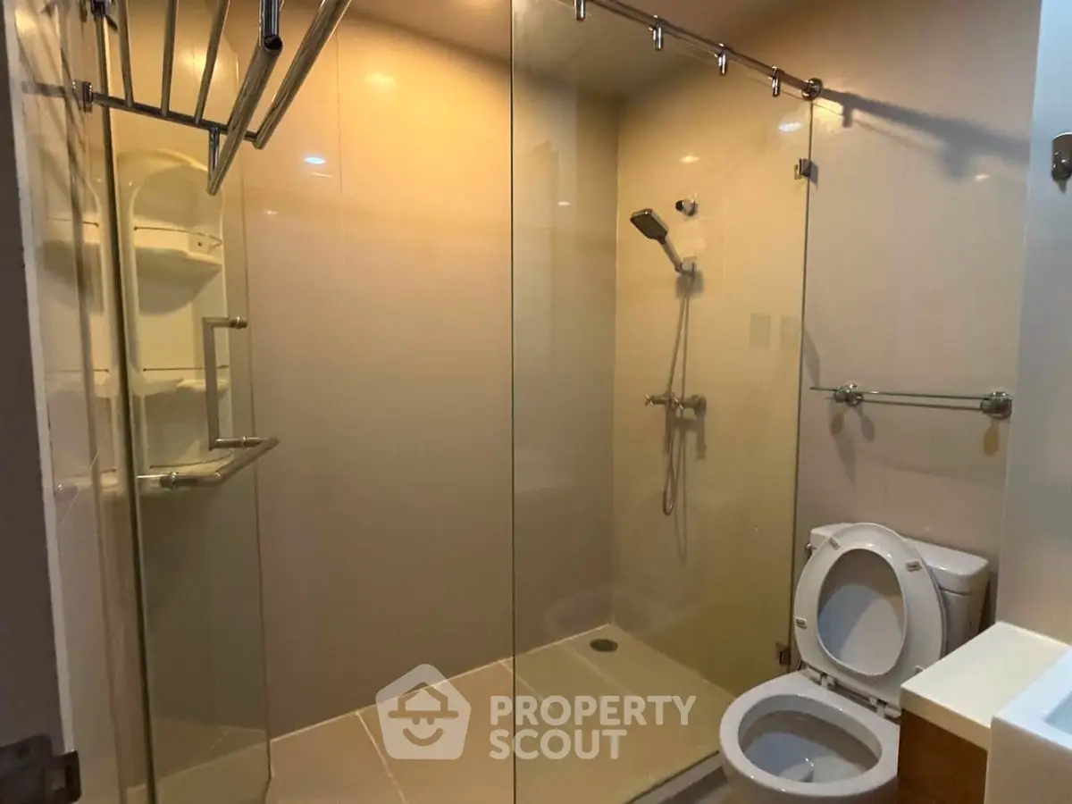 Modern bathroom with glass shower enclosure and sleek fixtures