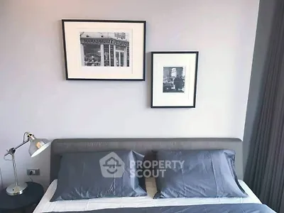 Modern bedroom with stylish decor and framed art above bed