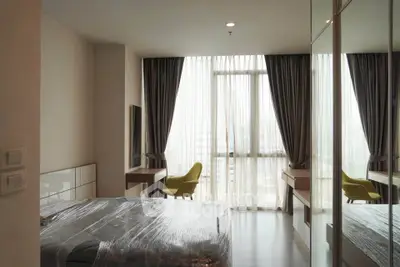 Modern bedroom with floor-to-ceiling windows and stylish furnishings