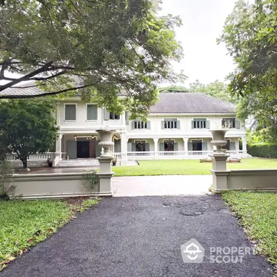 Elegant two-story mansion with lush garden and spacious driveway