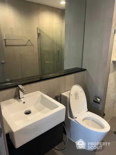 Modern bathroom with sleek fixtures and glass shower enclosure