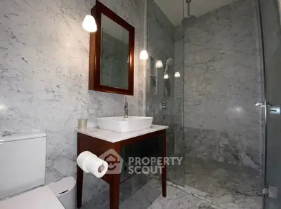 Luxurious marble bathroom with modern fixtures and elegant lighting