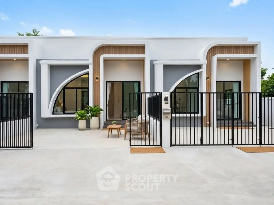 Modern single-story home with unique architectural design and gated entrance.