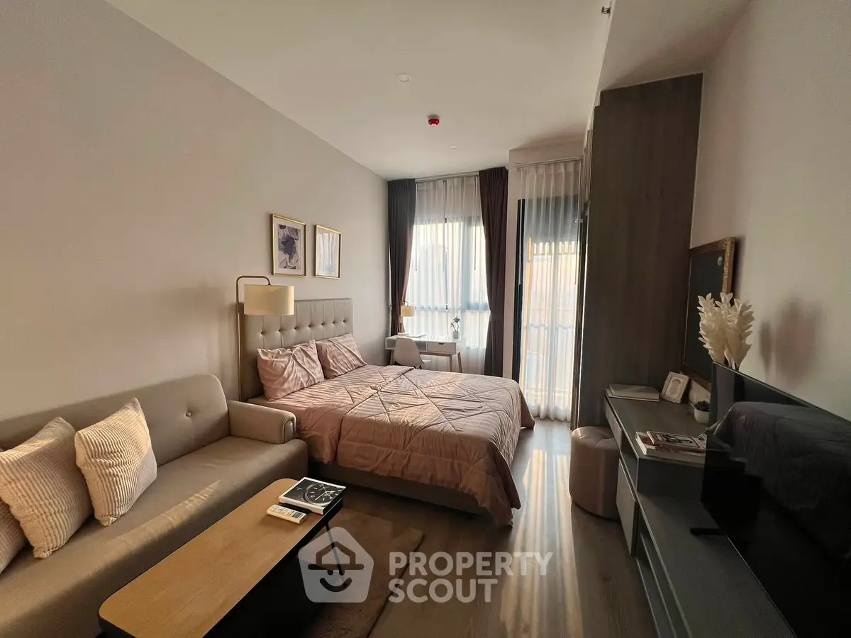 Cozy bedroom with modern decor and natural light, featuring a comfortable bed and stylish furnishings.