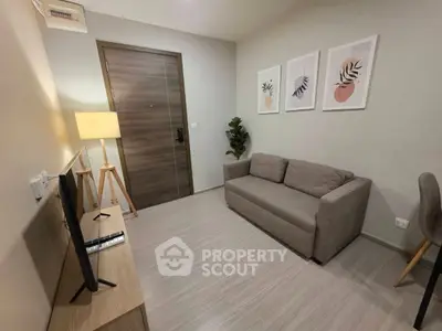 Modern living room with cozy sofa, stylish decor, and flat-screen TV in a contemporary apartment.