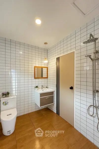 Modern bathroom with sleek fixtures and white tile walls