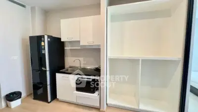 Modern compact kitchen with sleek appliances and ample storage space.