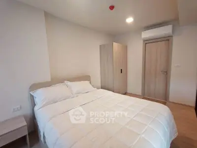 Modern bedroom with minimalist design and air conditioning in a cozy apartment.
