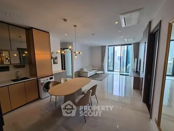 Luxurious open-plan living room with modern kitchen and city view balcony