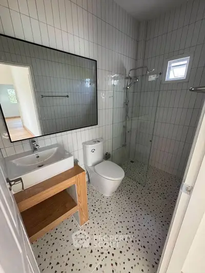 Modern bathroom with glass shower and stylish tile flooring