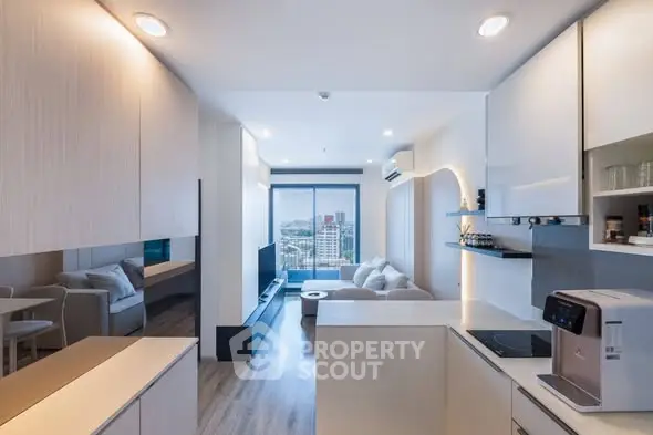Modern open-layout living room with sleek kitchen and city view, featuring contemporary design and natural light.