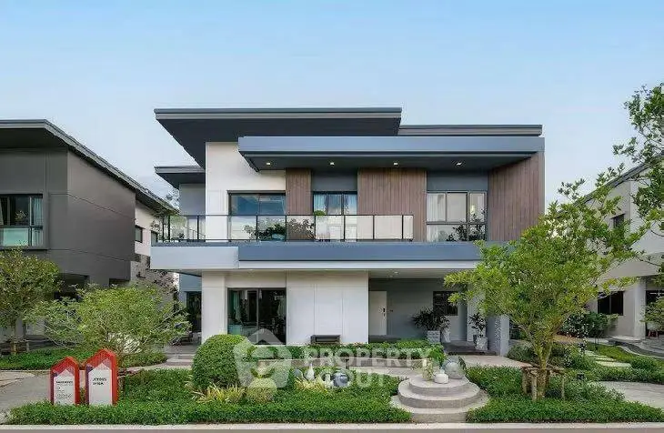 Modern two-story house with sleek design and lush landscaping in a serene neighborhood.