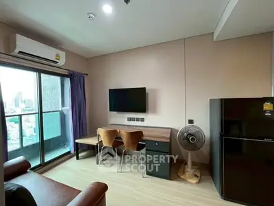 Modern living room with balcony view, air conditioning, and sleek furniture.