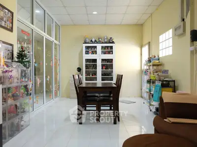 Spacious dining area with modern decor and ample natural light, perfect for family gatherings.