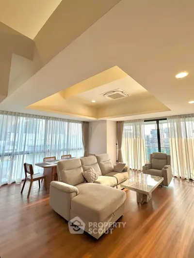 Spacious living room with modern furniture and panoramic city views