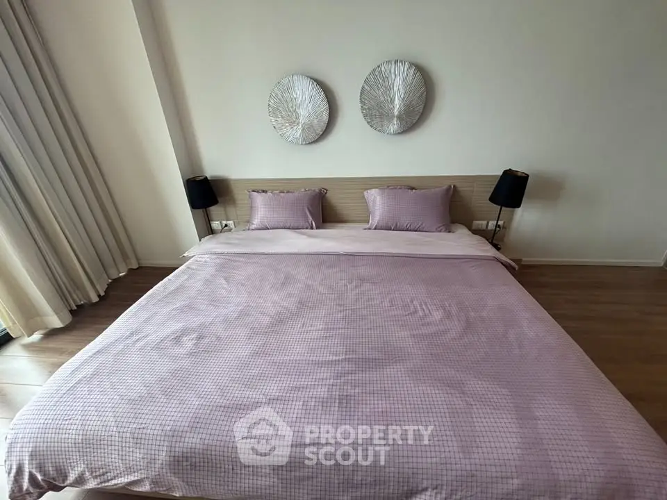 Spacious bedroom with elegant decor and large bed in modern apartment
