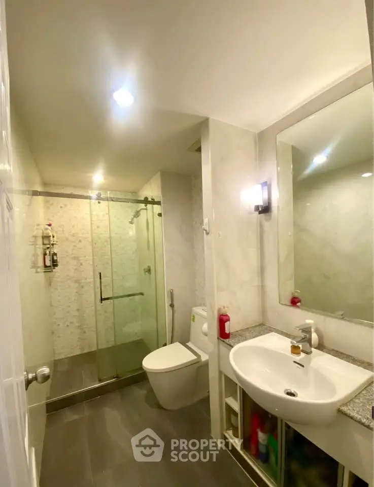 Modern bathroom with glass shower and sleek fixtures