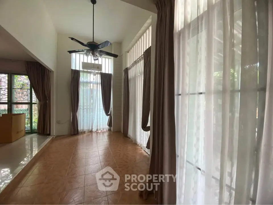 Spacious living room with high ceilings and large windows for natural light