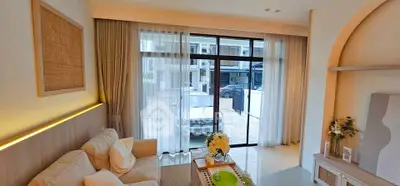 Modern living room with large window and cozy seating area