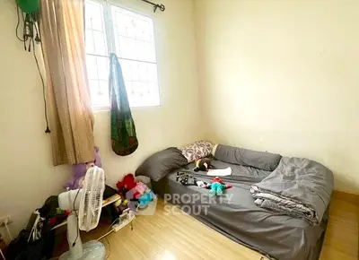 Cozy bedroom with natural light and minimalist decor, perfect for relaxation.