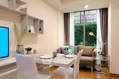 Modern living room with stylish decor and garden view, featuring cozy seating and elegant dining area.