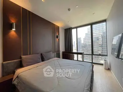 Luxurious bedroom with stunning city view and modern decor in high-rise apartment.