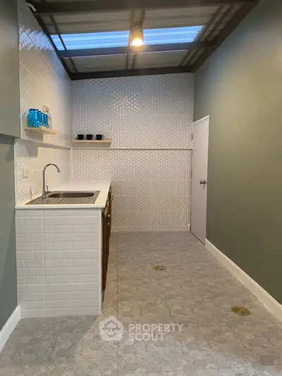 Modern kitchen with sleek design and open layout, featuring stylish backsplash and ample counter space.