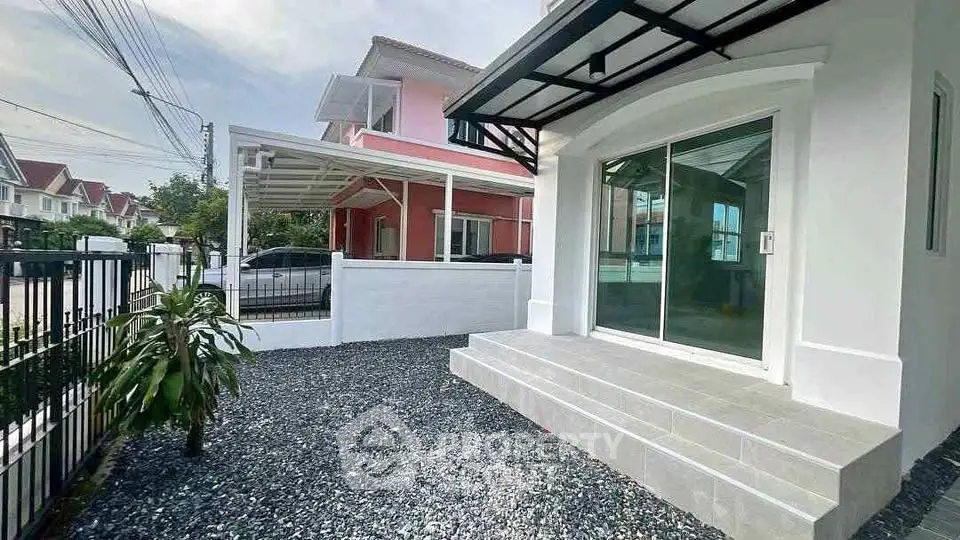 Charming residential home with modern exterior and spacious front yard in a serene neighborhood.