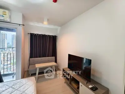 Cozy living room with modern furniture and city view from balcony.