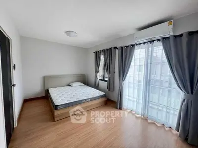 Spacious bedroom with natural light and modern decor in a stylish apartment.