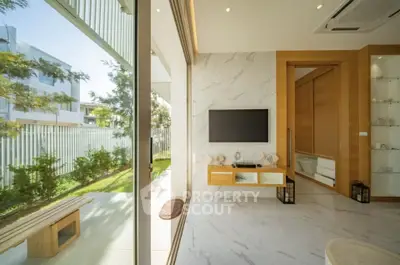 Luxurious modern living room with marble flooring and garden view