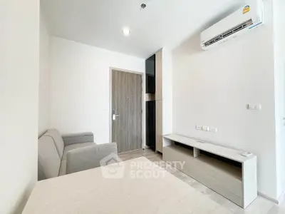 Modern living room with sleek furniture and air conditioning in a contemporary apartment.
