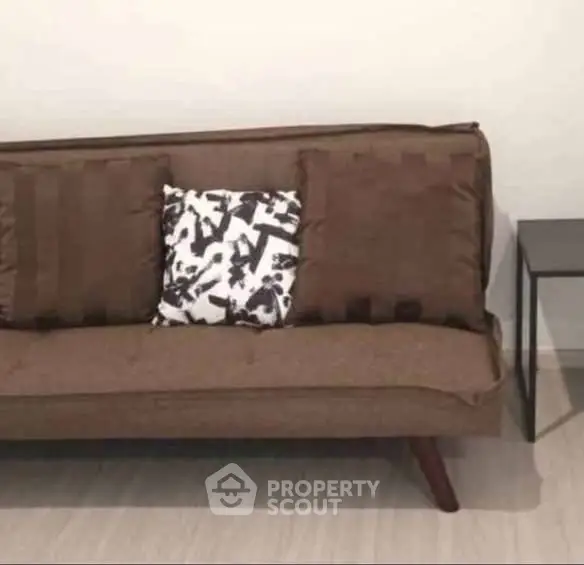 Stylish brown sofa with modern design in a cozy living room setting.