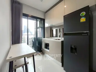 Modern kitchen with sleek appliances and city view from balcony