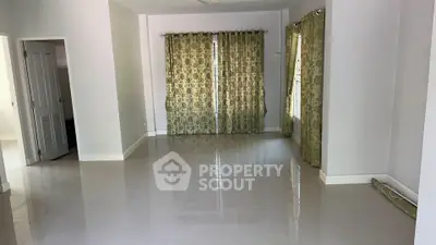 Spacious empty living room with tiled floor and elegant curtains