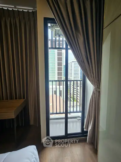 Modern bedroom with balcony view in urban high-rise apartment