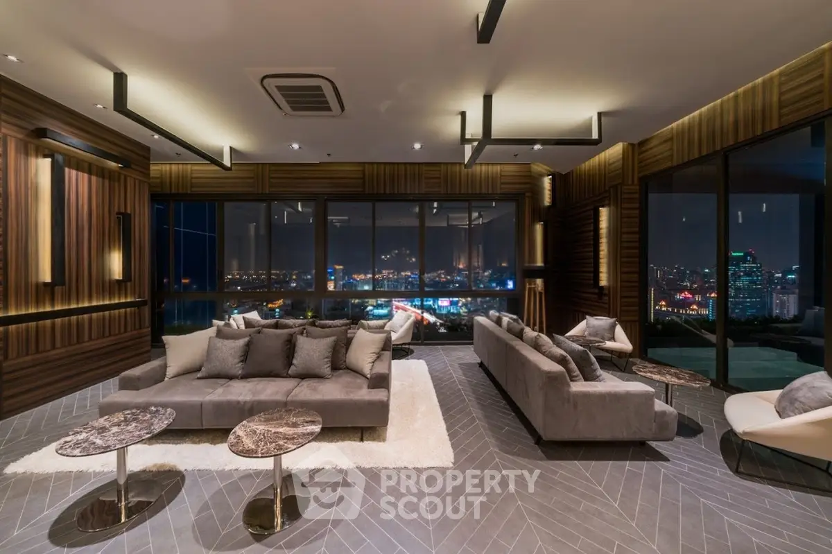 Luxurious modern living room with stunning city view and elegant furnishings.